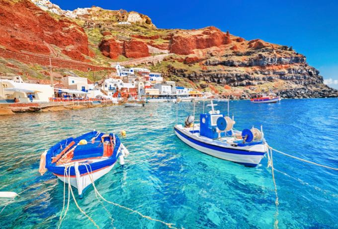 greece-breathtaking-beautiful-landscape-of-two-fishing-boats-anchored-to-quay-in-fascinating-blue-water-at-the-amazing-old-port-panorama-in-oia-ia-village-on-santorini-greek-island-in-aegean-sea-3